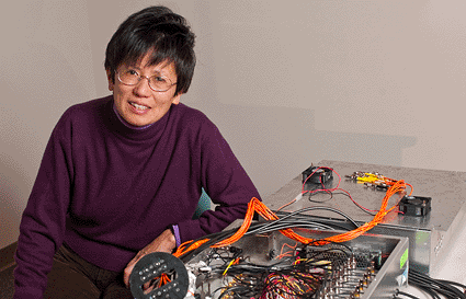 Image: Quing Zhu, professor of electrical and computer engineering, with her device for early detection of breast cancer lesions (photo courtesy of Peter Morenus).